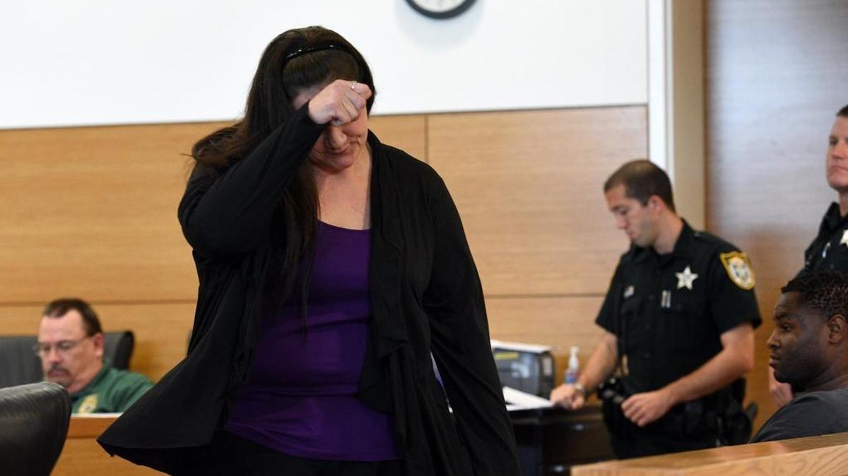 Alexander Marr's mother, Dianna Marr, tries to hide her face as she leaves a hearing at the Judicial Center. Marr, charged in the boy's death, is scheduled to tried the week before Christmas.