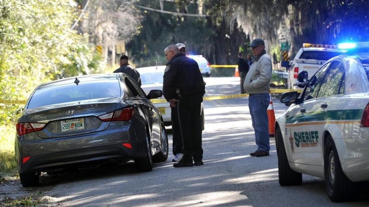 Law enforcement investigates the scene where the body of a woman believed to be in her 20's was found on Bishop Harbor Road Tuesday afternoon. The death is being treated as a homicide, according to officials.