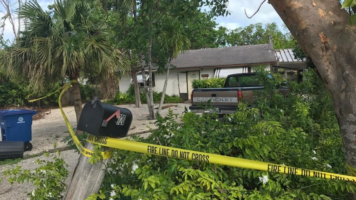 Yellow tape surrounds a house at 720 Ponce de Leon Blvd. in Key Largo where the body of 70-year-old Mary Bonneville was found Saturday by Key Largo volunteer firefighters. Detectives believe she died before the fire based on wounds they found on her body.