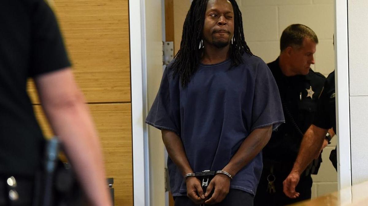 Ahmad Dunbar, one of two defendants in the Jan. 19 fatal shooting of Karl Tuxford and fatal stabbing of Jordan Finlon winks as he is escorted into a courtroom June 14, 2016 where a judge ordered him to provide detectives a sample of his DNA and fingerprints.