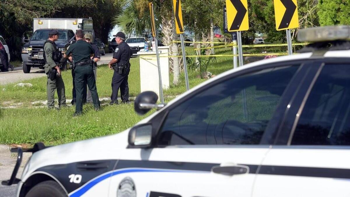 Police officers stand near investigators in Palmetto where at about 2 a.m., an incident near 25th Street West and Bayshore Road ended with two Palmetto police officers fatally wounding someone, Chief of Police Scott Tyler confirmed.