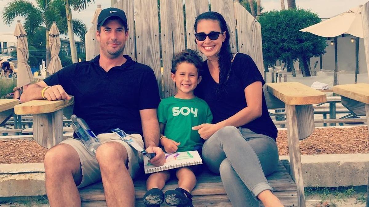 Scott and Finn McGuire, center, and Suzy Rivera took what would be their last family vacation in the summer of 2015 in Florida.