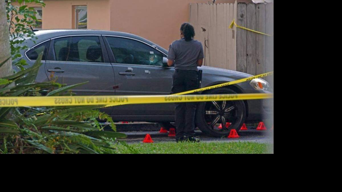 Investigators scour the scene where a father of three and the husband of an Opa-locka police officer was shot and killed outside of a Miramar home, Thursday October 29, 2015