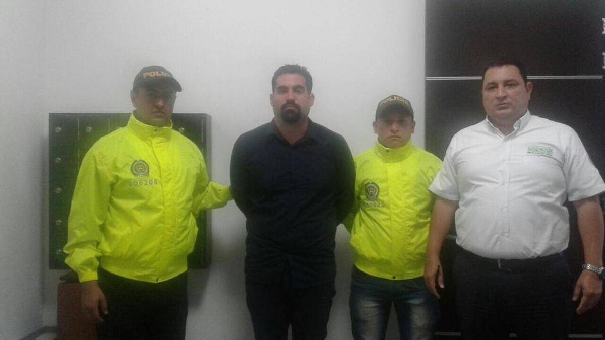 Andres Collazos, second from the left, with Colombia authorities after he apprehended him so that he could be extradited and face charges including murder for the death of ex-girlfriend Jazmin Catano.