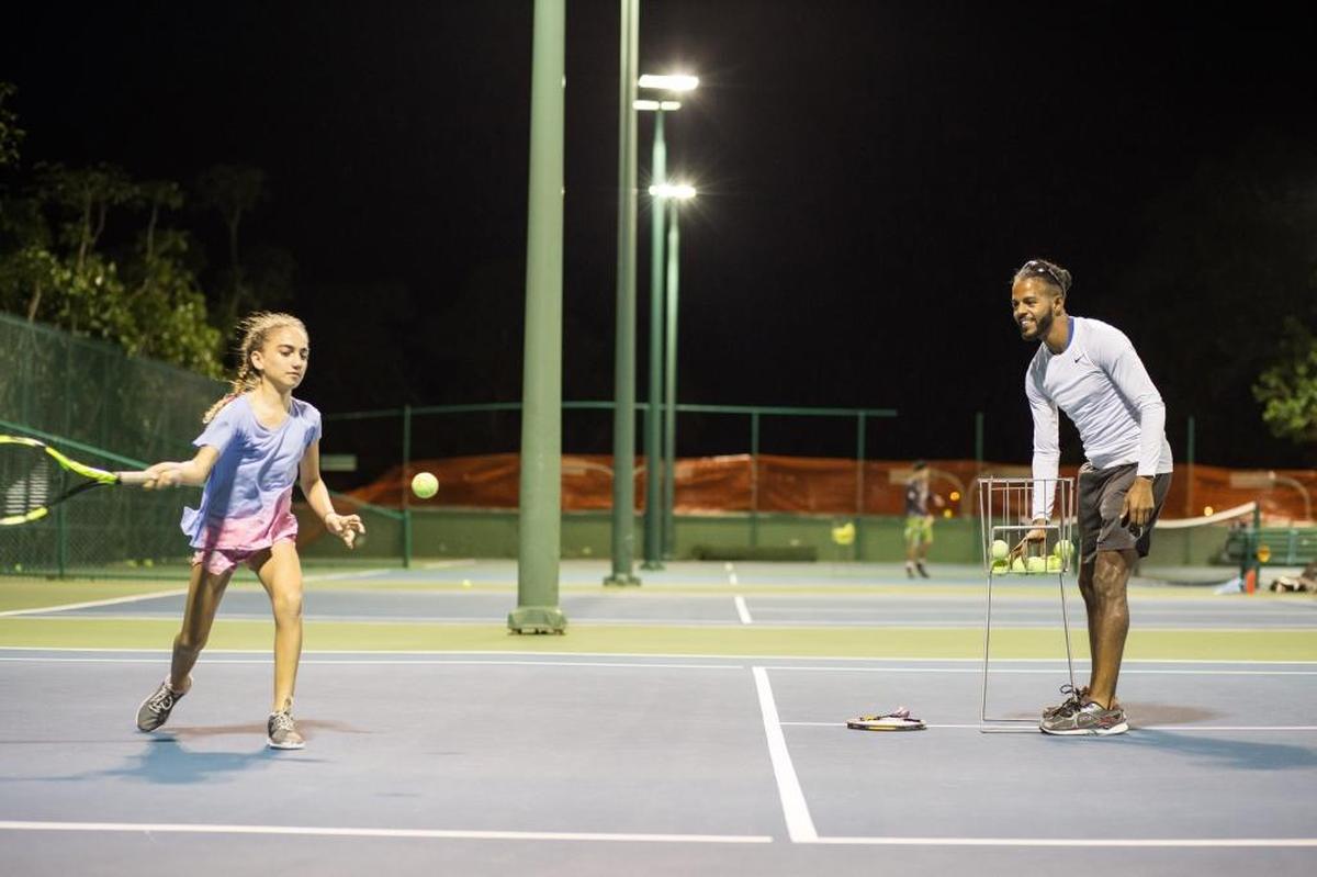 Tennis instructor Osmailer Torres, accused of hitting a 5-year-old, trains his student Nadia Ahmadi at Brickell Bay Club in Miami on Monday, December 4, 2017.