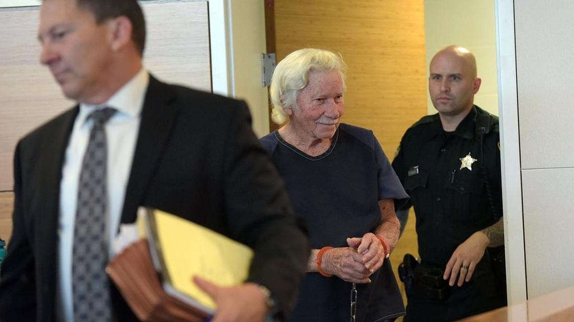 Eugene Matthews, charged with second-degree murder with a firearm in the fatal shooting of his late best friend's ex-wife, smiles to family and friends as he arrives in court for a bond hearing.