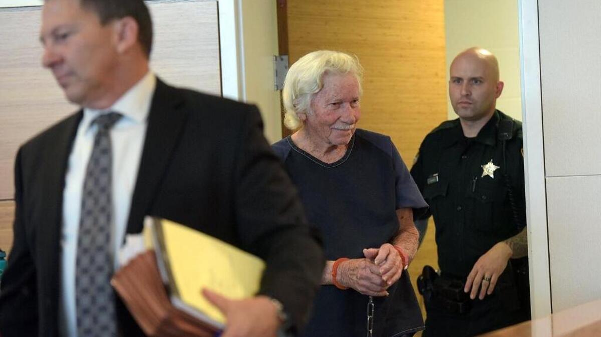 Eugene Matthews, charged with second-degree murder with a firearm in the fatal shooting of his late best friend's ex-wife, smiles to family and friends as he arrives in court for a bond hearing.