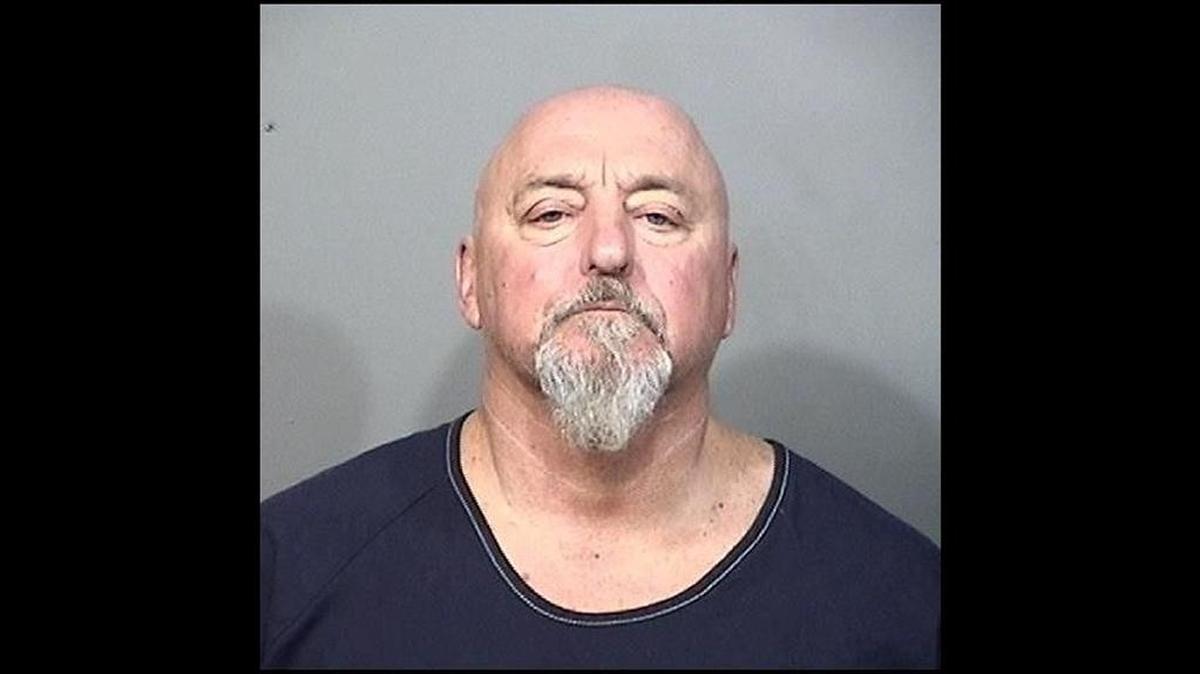 William Lewis, 62, is being held on $100,000 bail after police say he pushed his girlfriend off a second-story balcony on Sunday, causing her severe head trauma and brain bleed.