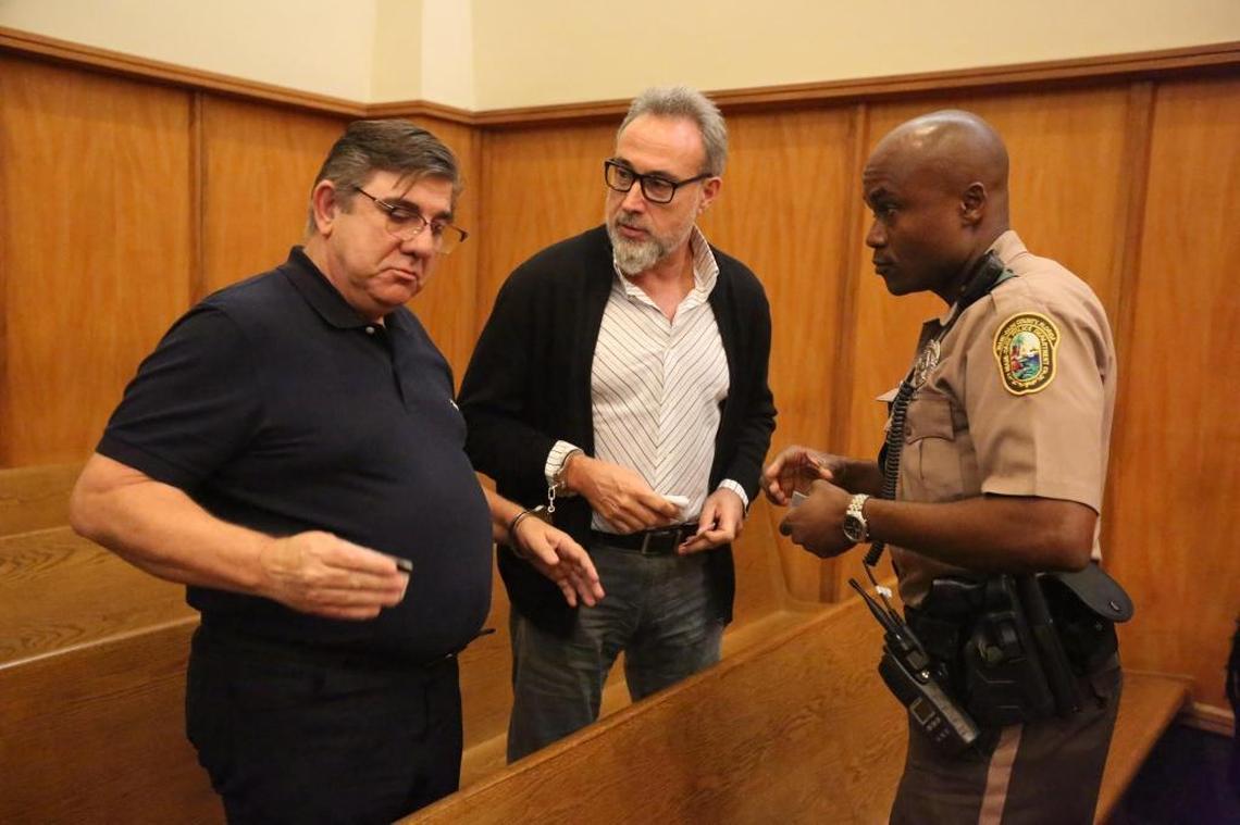 Alejandro Sanchez Del Arco, regional vice president of RIU and Luis Riu Guell, Jr. , right, chairman of the RIU hotel chain surrendered in a Miami court earlier this year. They face allegations of giving free hotel stays to a Miami Beach city official in exchange for help with building permits.