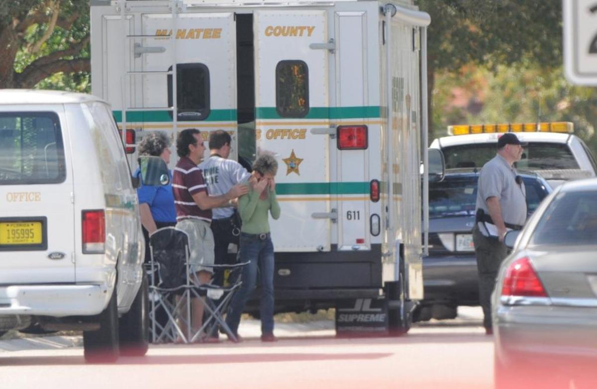 Loved ones comfort each other at the scene of a possible homicide Monday in the 11000 block of Hyacinth Way at Riverwalk Hammock in Lakewood Ranch, where the body of Ina Gross, 77, was found in her garage.