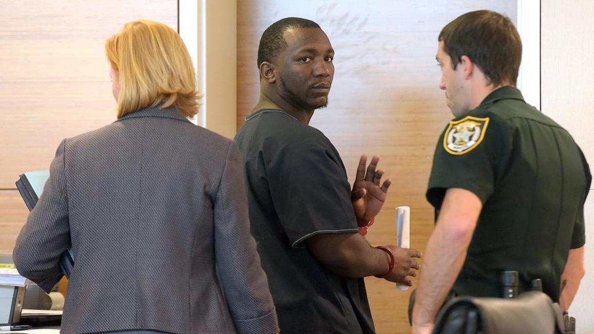 Faheem Nelson, 24, waves to his mother as he is led from a courtroom Thursday. Nelson pleaded no contest Friday morning to drugs charges that included trafficking in heroin and sale or delivery of carfentanil. Nelson appeared in court Thursday, but the hearing was pushed back when an agreement could not be made.