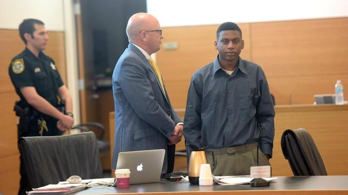 Defense attorney Bjorn Brunvand, left, stands with Trey Nonnombre, 21, Friday at the Manatee County Judicial Center. Nonnombre is charged with two counts of first-degree murder and armed home invasion in the July 9, 2015, fatal shootings of Esther Deneus and her boyfriend, Kantral Markeith Brooks, both 29.