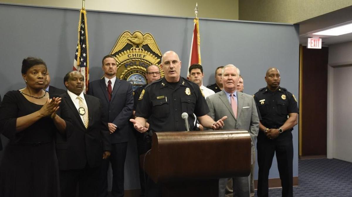 In a Nov. 28, 2017 photo, while Tampa Mayor Bob Buckhorn and Police Chief Brian Dugan announce that police had caught the man they believe responsible for the four slayings in Seminole Heights, the woman at the left, identified by police as Derlyn Roberts, was interpreting in American sign language that was largely indecipherable.