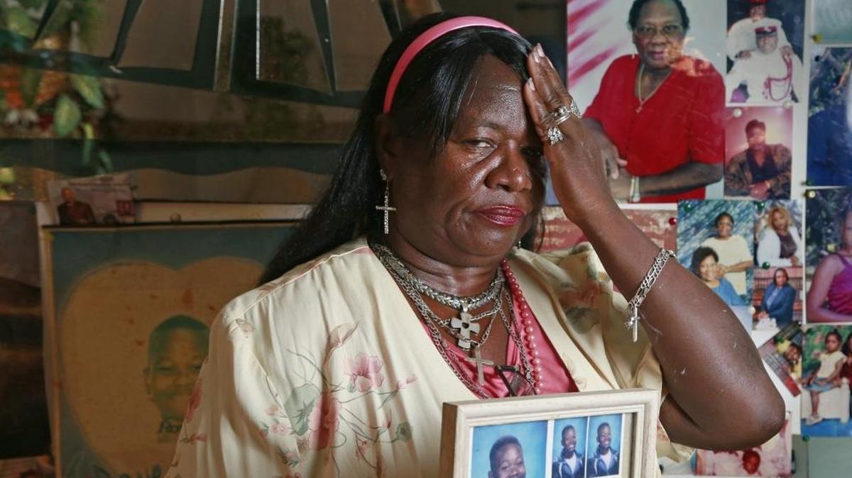 Della Wright with a portrait of her son Jerome Wright, as a young boy, at her home in Miami.