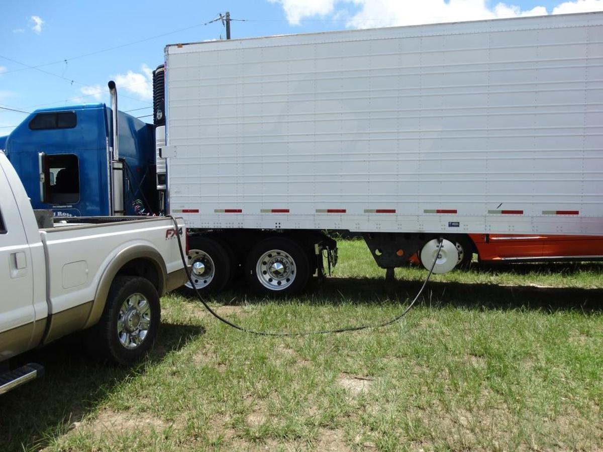 Miami-Dade police photo of a suspected illegal fuel truck gassing up a tractor-trailer truck. The suspect, Damian Martinez, is awaiting trial.
