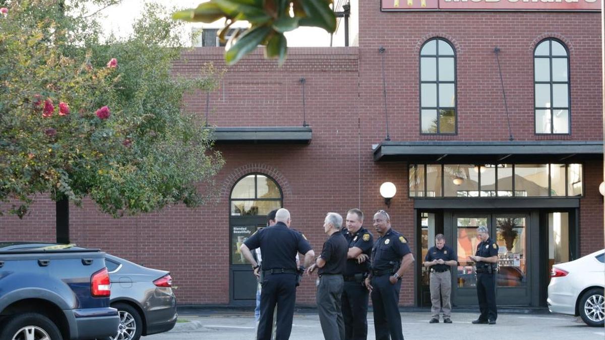 Police investigate Tuesday at the McDonald’s in Tampa’s Ybor City. The manager of the restaurant will receive a $110,000 reward for her tip that led to the arrest of Howell Emanuel Donaldson, 24, who is charged with four counts of first-degree murder.