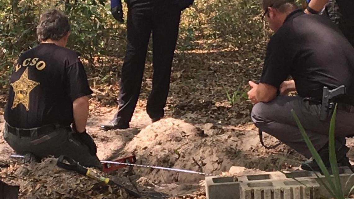 Law enforcement officers work at the scene where Tricia Freeman’s body was found in Chiefland.