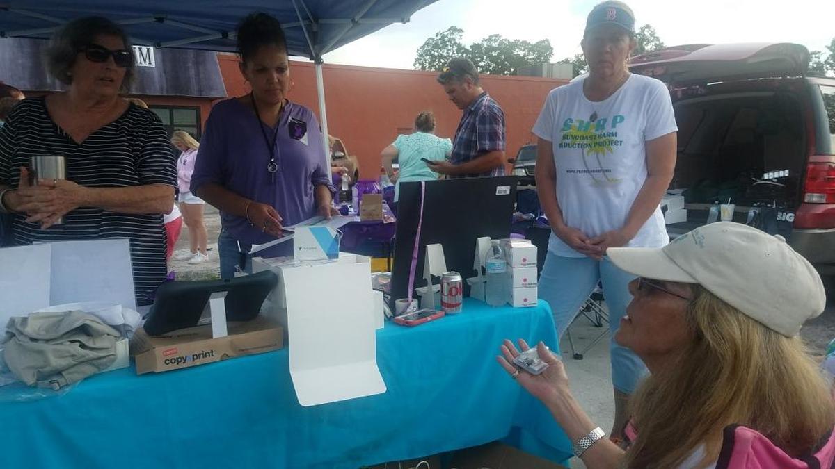 Peggy Toledo, center, and others listen as Julia Negron, co-founder of Suncoast Harm Reduction Project, trains them in how to use Narcan nasal spray to revive an overdose victim in Manatee County in observance of International Overdose Awareness Day. Toledo’s husband, Edwin Jusino, died on Nov. 8, 2016 from a carfentanil overdose.