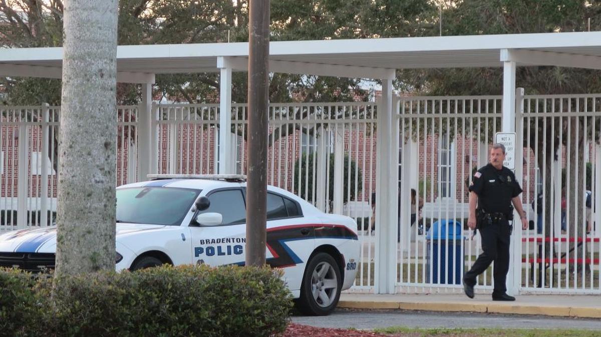 FILE: An officer patrols the campus of Manatee High School on foot Wednesday morning. Police found notes threatening violence to Manatee High School and made arrests. The school district has had increased security on all school campuses since last week.