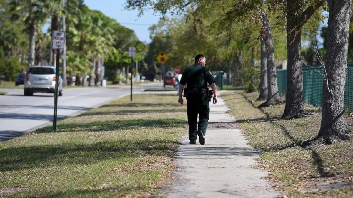 Manatee County Deputy Kenny Cristello walks the perimeter of Prine Elementary School Monday morning as more school resource officers are deployed at county schools.