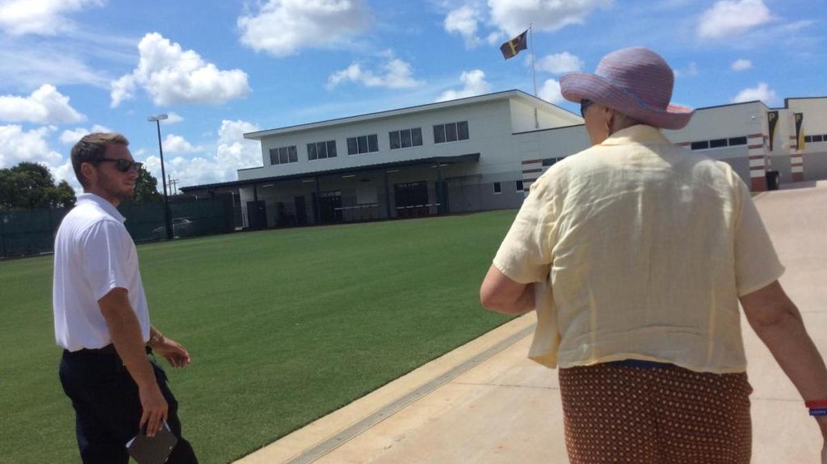 Nick Long, coorindator of McKechnie Field operations, walks with Karen Carpenter through the field Friday. Carpenter chairs the annual Bradenton Kiwanis Christmas in August event, which helps homeless students prepare to go back to school.