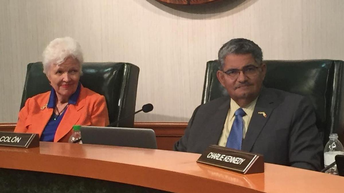 Board members Karen Carpenter and John Colon at Tuesday night’s board meeting. The board approved new impact fee rates and recommended collecting the rates at 100 percent.