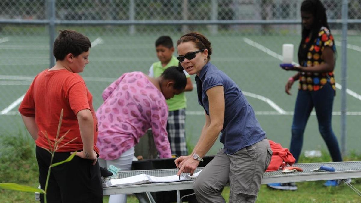 Teacher Kimberley Lough talks with students as they spend time in the school’s garden during agriscience class last May at Lincoln Middle School in Palmetto.
