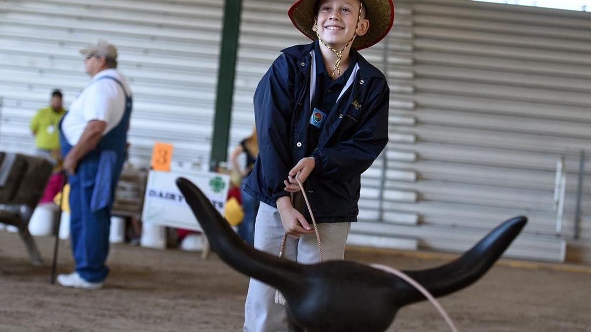 Gracen Berlin, 9, of Suncoast Baptist School learns how to rope a steer with a thousand other Manatee County third graders gathered at the Manatee County Fairgrounds for Ag-Venture.