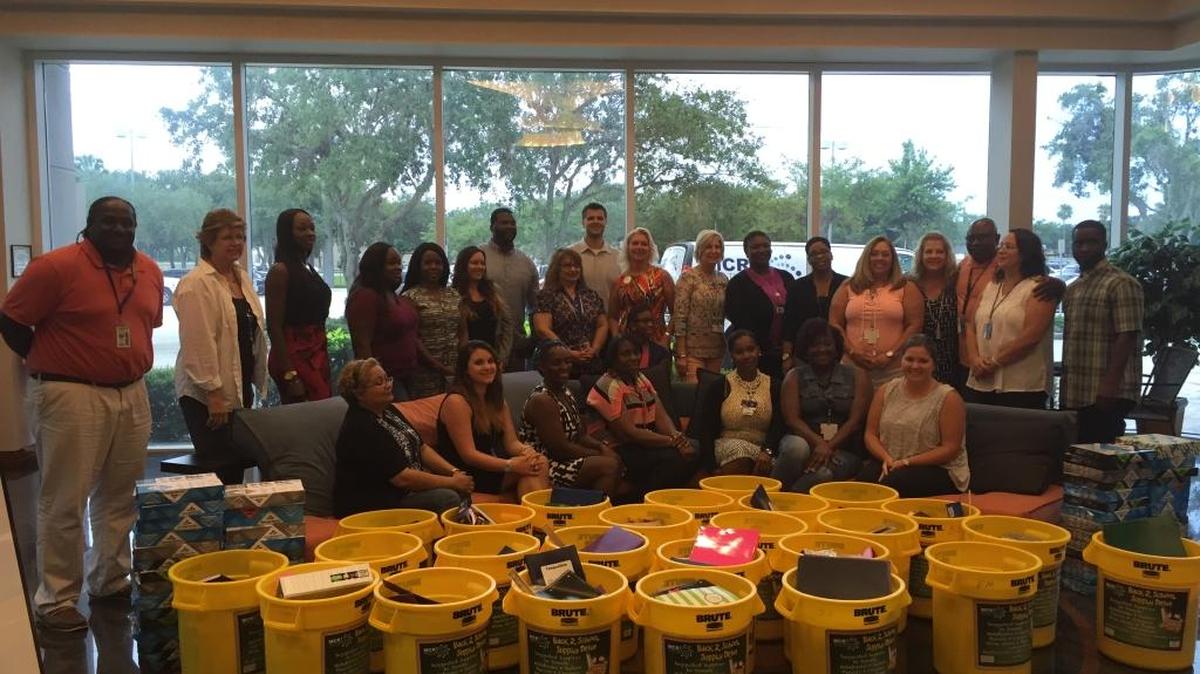 Graduation Enhancement Technicians pose with donations from MCR Health Services Associates on Friday.