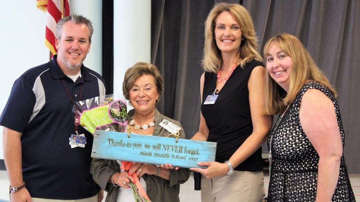 Haile Middle School teacher Jeff McDaniel, Holocaust survivor Rifka Glatz, Haile Middle School Principal Sharon Scarbrough and teacher Renee Lewis stand with Glatz last week after Glatz shared her story of surviving the Holocaust with more than 300 students.