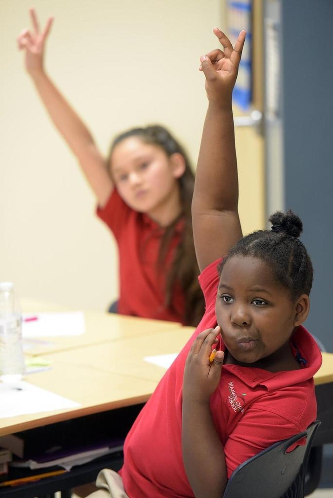 Meya Freeman, 8, a third-grader at Manatee Charter School, raises two fingers to signify the answer to a question Thursday. Manatee Charter School is fighting for its survival this year, as new leaders attempt to change the culture of a school that the School District of Manatee County has threatened to shut down.
