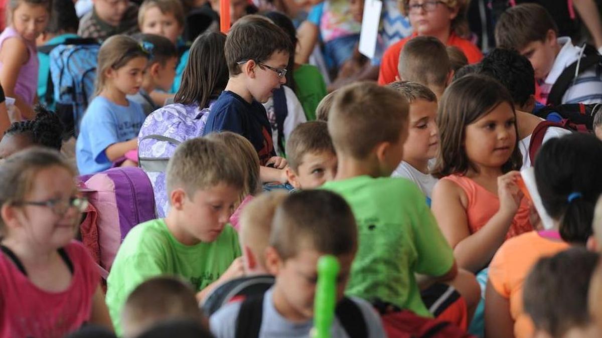 Students at Mills Elementary School wait for their ride Friday, the last day of the 2014-15 school year.