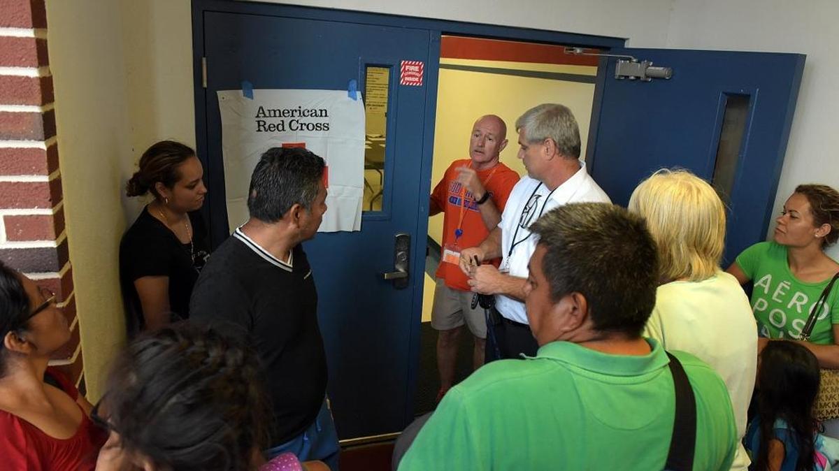 Manatee High assistant principal George Schrier opens the doors to an evacuation shelter at the school. Almost 30 people were lined up, most from Ft. Pierce, to escape the effects of Hurricane Matthew. Make-up days were recently announced.