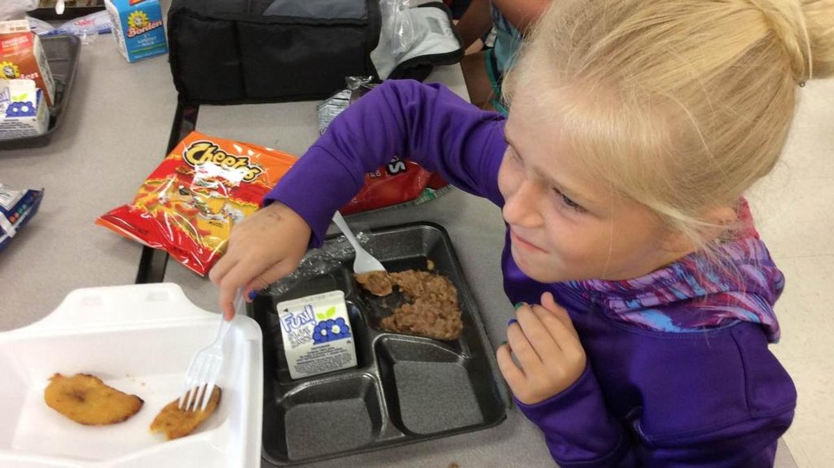 Seven-year-old Ella Philpot, a second-grade student at Gullett Elementary School, makes a face after eating a plantain for the first time at the school as part of Hispanic Heritage Month.