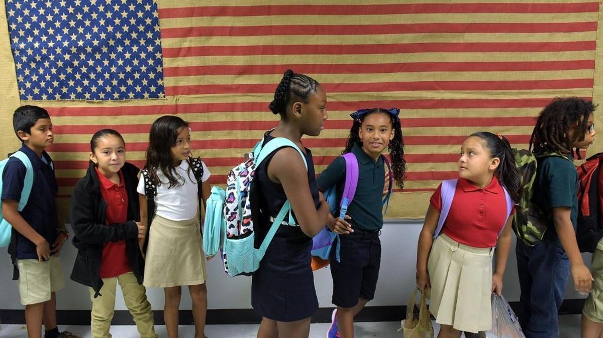 Students line up in hallways at Rogers Garden-Bullock Elementary School on the first day of school.