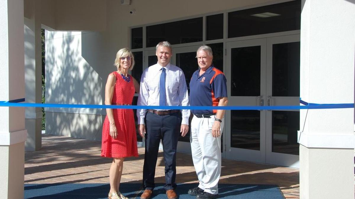 Officials stand outside the new middle school building on the Bradenton Christian School campus Friday.