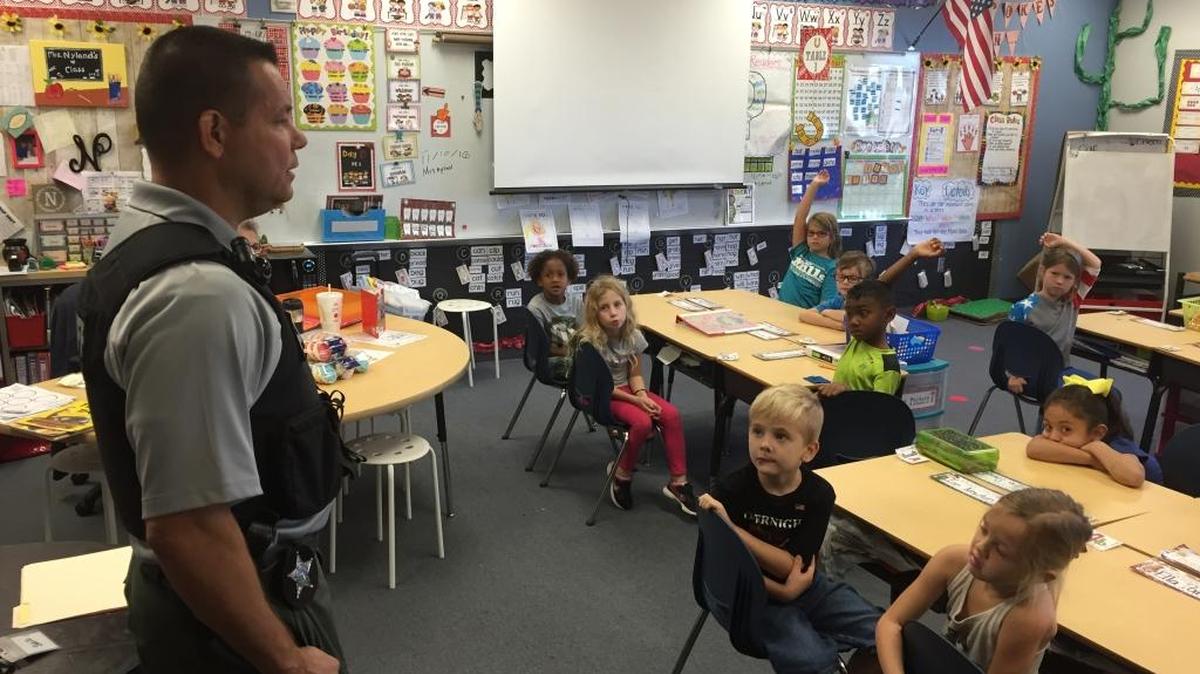 Manatee County Sheriff’s Office Sergeant Jim Anderson speaks with kindergarten students at Virgil Mills Elementary School in Palmetto on Thursday, Nov. 10.