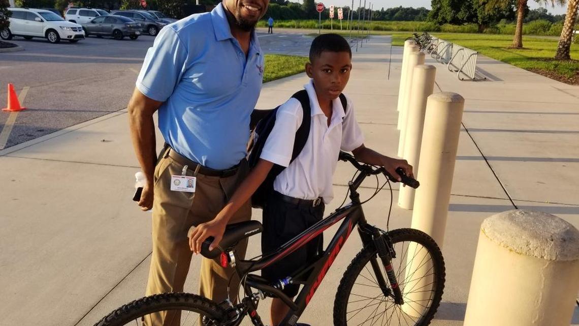 Billy Williams III, a graduation enhancement technician at Manatee Charter School, got Walmart to donate a bike so Jamarion Gambles, 12, would have a way to get to school.