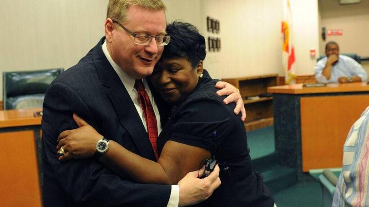 In this file photo, Don Hall hugs Diana Greene, deputy superintendent, after being sworn in Wednesday as interim superintendent of Manatee County District Schools.