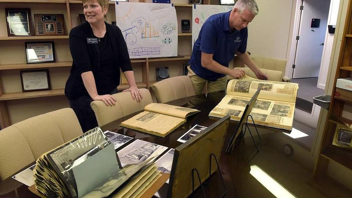In this file photo, Dawn Stanhope, President, and Drue Duerschmidt, marketing and communications, go through old scrapbooks and photographs at the Boys & Girls Club of Manatee.