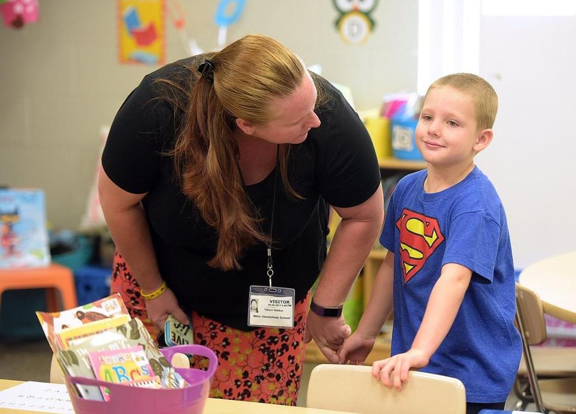 Tiffani Walker says goodbye to son, Dusty, 5, on the first day of school at Jessie P. Miller in Bradenton Thursday.