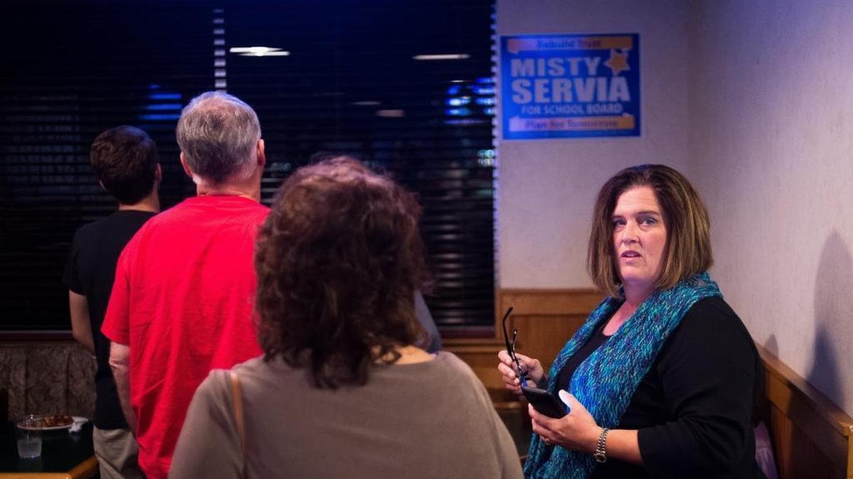 Misty Servia glances up from her phone while checking election results as votes come in for the Manatee County School Board election on Election Day, Tuesday, November 8, 2016 at Demetrios' Pizza House in Bradenton.