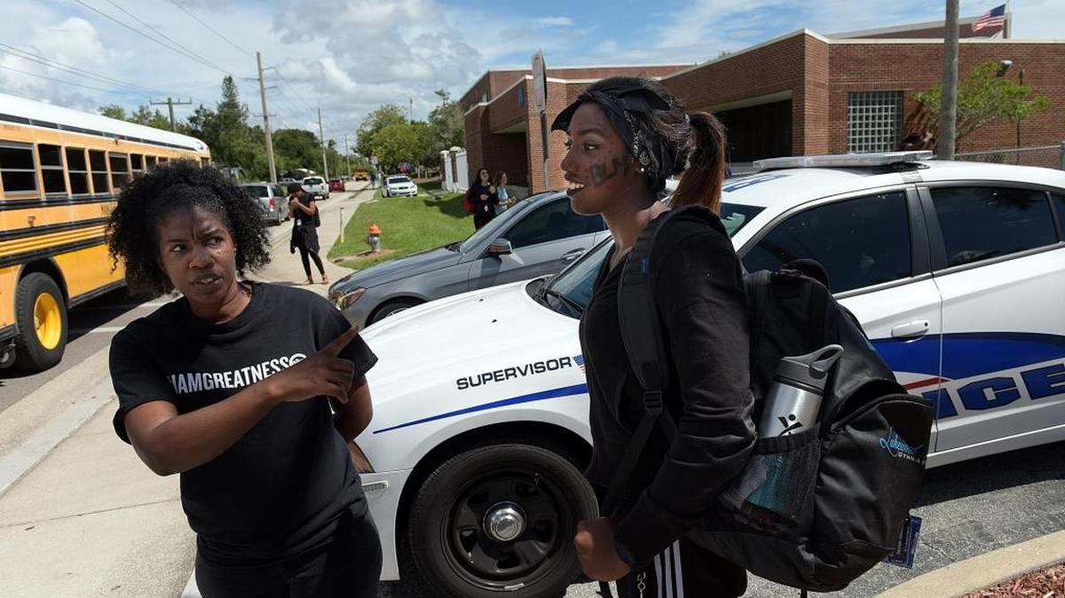 Takisha Gobourne and her daughter, Derrian, 16, talk about their feelings after a spirit day event at Manatee High School Wednesday spurred a gathering of students in protest Thursday.