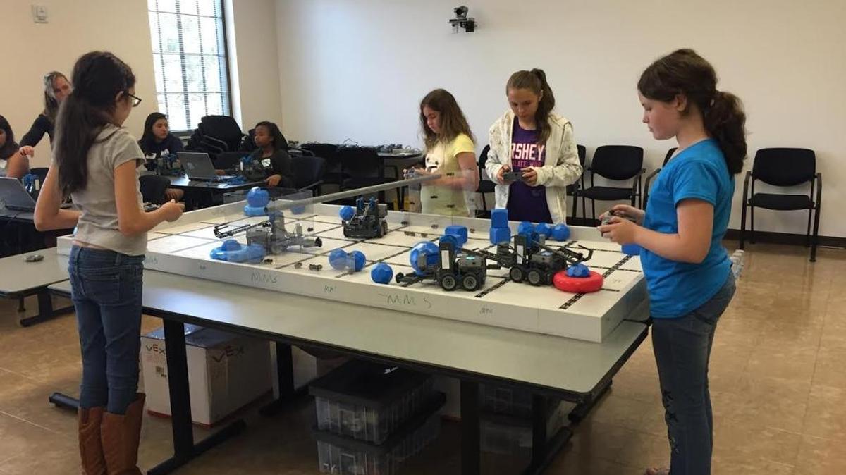 Girls program and drive VEX IQ robots during the 2016 Tech Savvy Workshop at the University of South Florida Sarasota-Manatee.