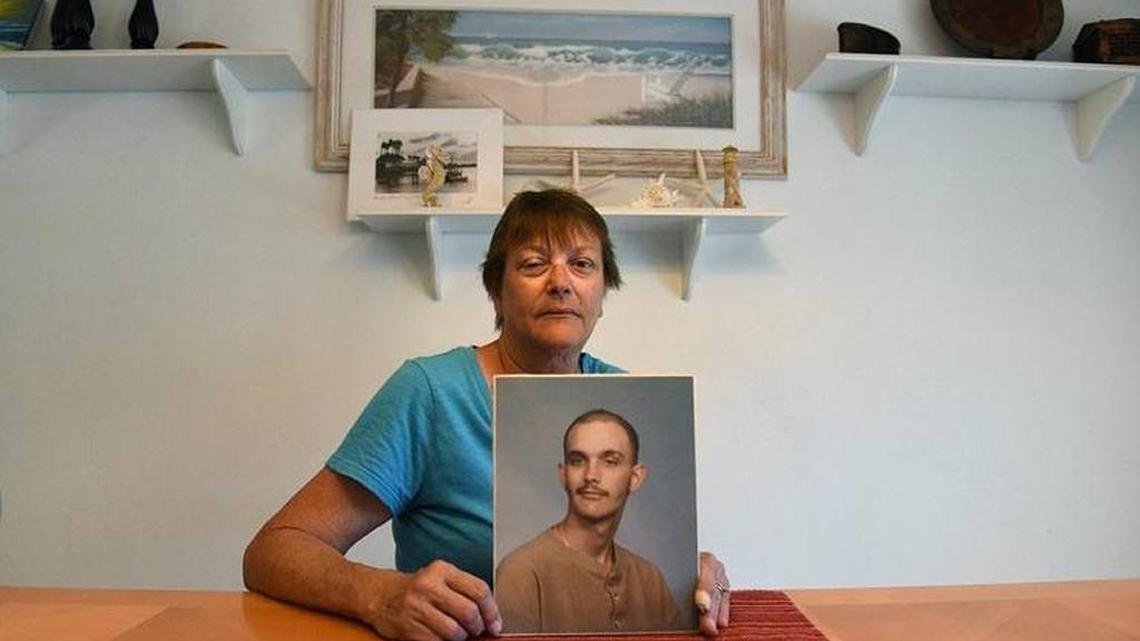 Liz Reed talks about her son, Rick, as she holds a picture that usually hangs on the wall. Rick died of Ewing's sarcoma 20 years ago. He only attended Bayshore High in his freshman year, but she's convinced that his cancer and the high school is related.