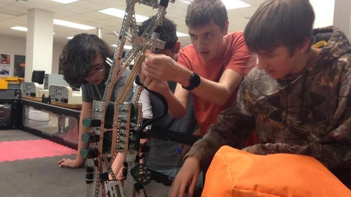 Brantley Deines, 15, adjusts the Braden River High School’s robot. He is flanked by teammates Lincoln Benedicto, Jehzel Maldonado and Reid Kauffman. Braden River set a record last weekend with the most trophies won at the TSA National Conference.