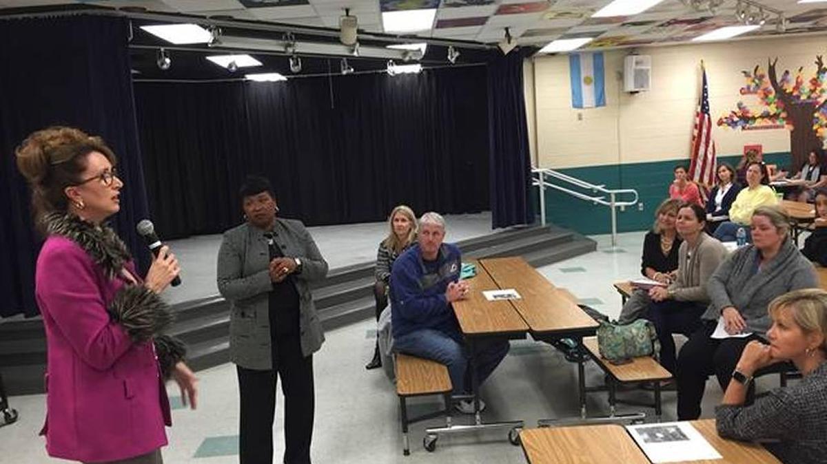 In this file photo, Deputy Superintendent of Instruction Cynthia Saunder and Superintendent Diana Greene talk to a group of parents.