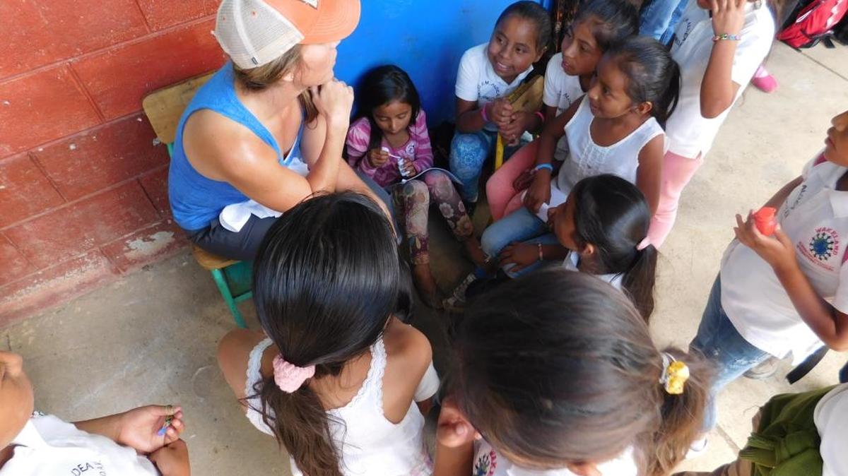 Amber Isaac, the parent of a Johnson Middle School student, sings with children during a recent visit to Guatemala.