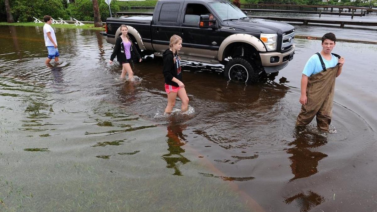 Dalton Francis, sisters Grace and Victoria Shtuka and Michael Micochero wade through the flood waters on Riverview Blvd. in Bradenton as Hermine approached the coast.