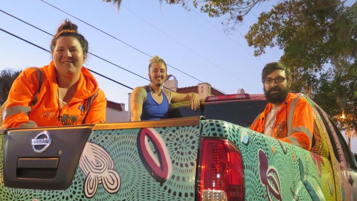 From left: Felici Asteinza, Kale Roberts and Joey Fillastre started work on the latest installation of public art along Old Main Street on Monday night. The aim of the street-applied art is to draw pedestrians from downtown to the Village of the Arts. The group is expected to work on the art installation at 9th Street West and 12th Street West from 8 p.m. to 5 a.m. Monday and Tuesday nights.